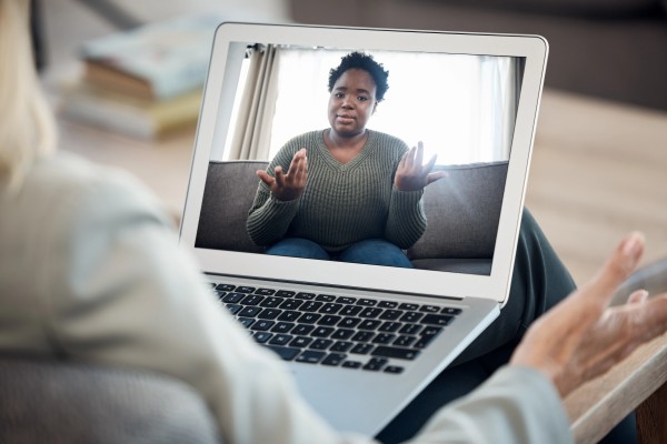 Young woman expressing her emotions through a therapy video call from the comfort of home. Young woman expressing her emotions through an adult therapy video call from the comfort of home.