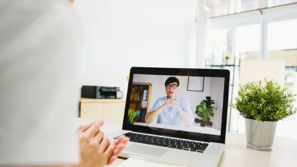 Specialist explaining the principles of Rational Emotive Behavioral Therapy (REBT) in a work video call.